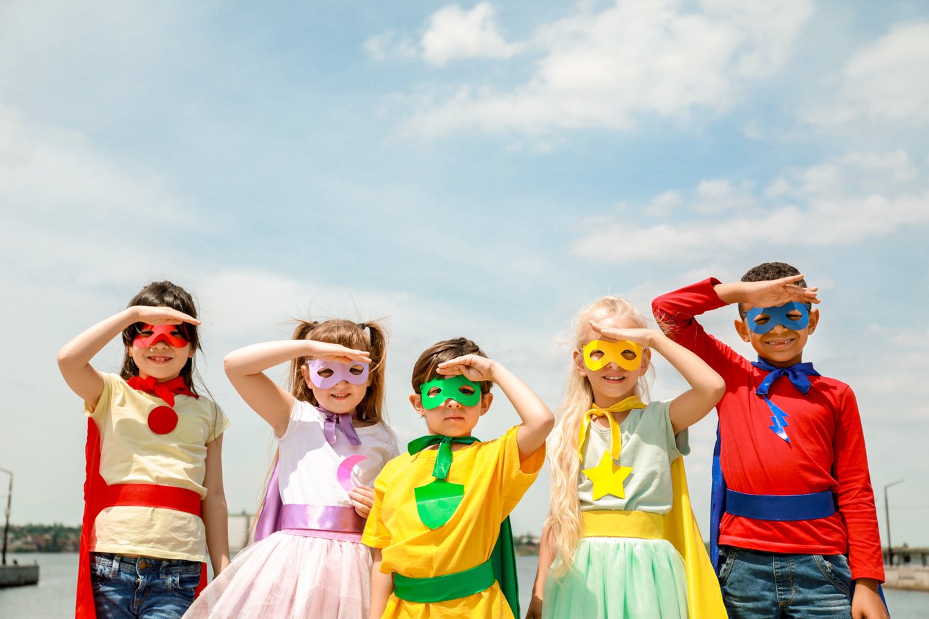 Cute Little Children Dressed as Superheroes Outdoors